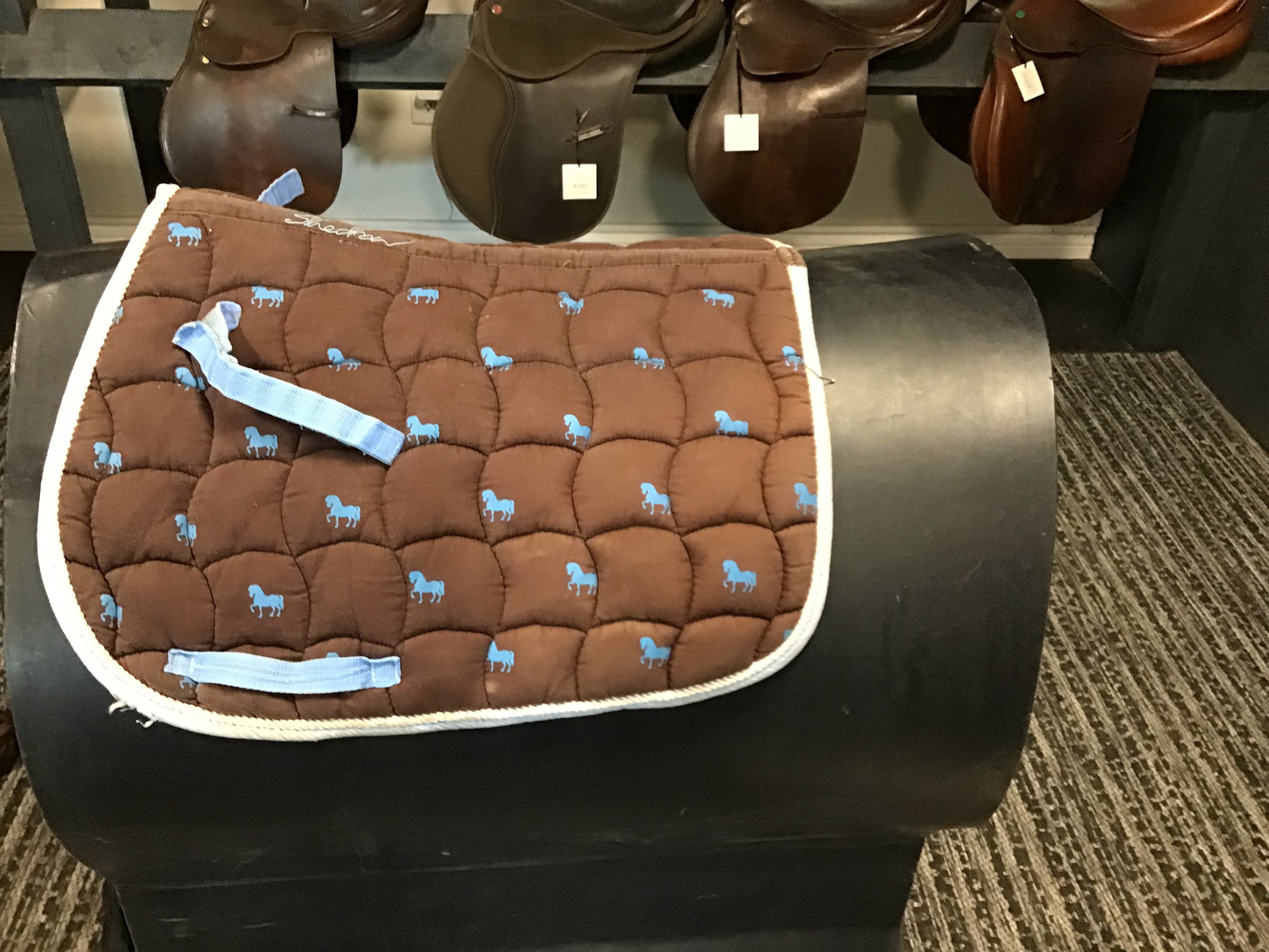 Brown and blue pony pad